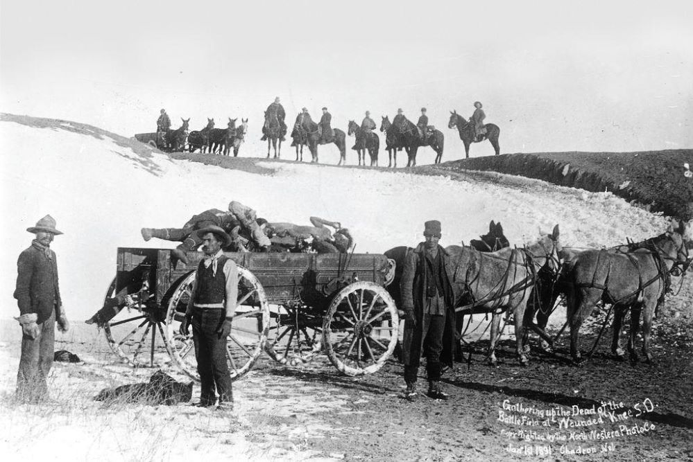 WK3 1WK Civilian burial party loading victims on a cart for burial